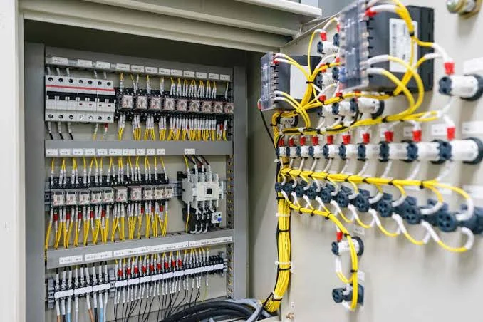 Industrial electrical control panel featuring Cable wiring, circuit breakers, terminal blocks, and reliable power distribution system.